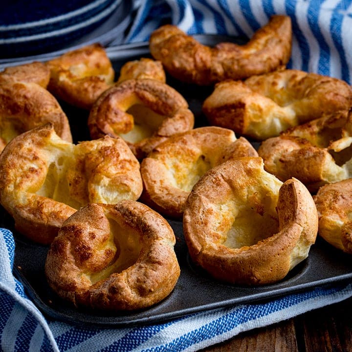 https://www.kitchensanctuary.com/wp-content/uploads/2017/06/Yorkshire-puddings-in-a-tin-on-a-wooden-table-square-FS.jpg